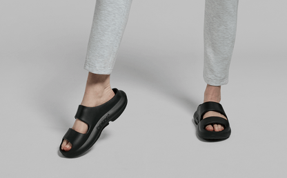 Women's OOyea Slide Sandal - Black front view of model standing in studio | lifestyle