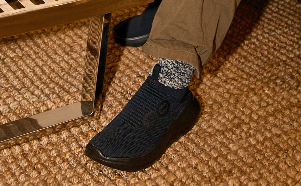 Men's OOmy Zen - Black close up of shoe on model sitting inside | lifestyle